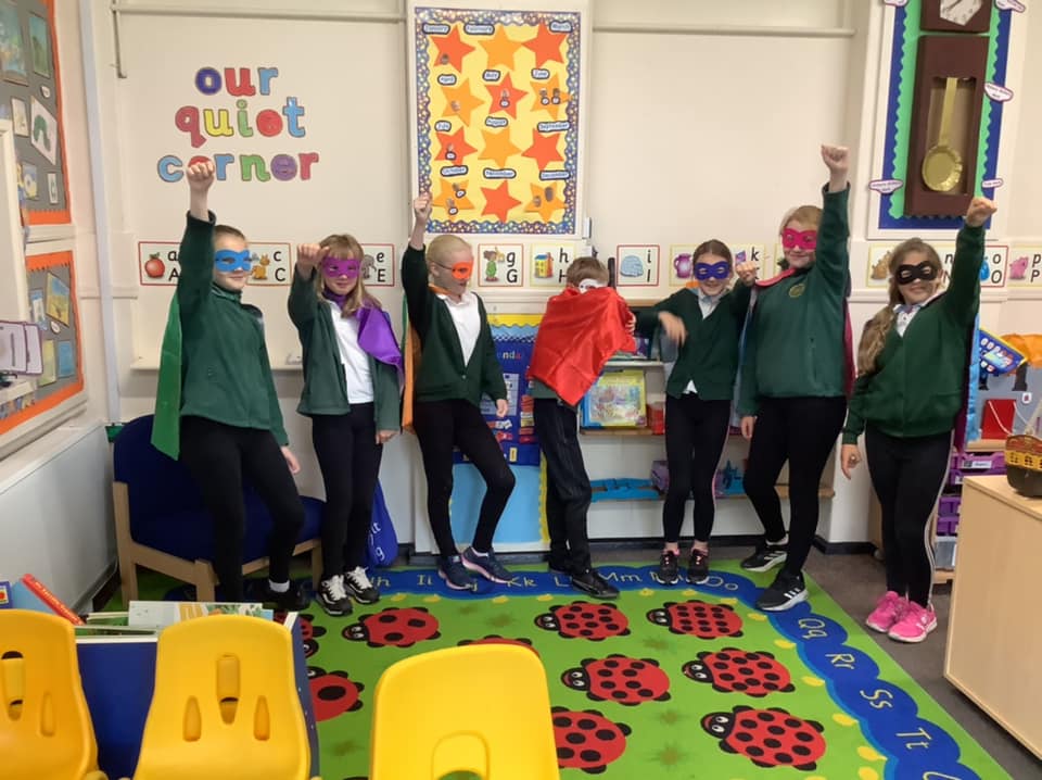 A group of children dressed in masks and capes as super heroes