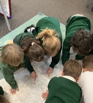 Children closely examining a map