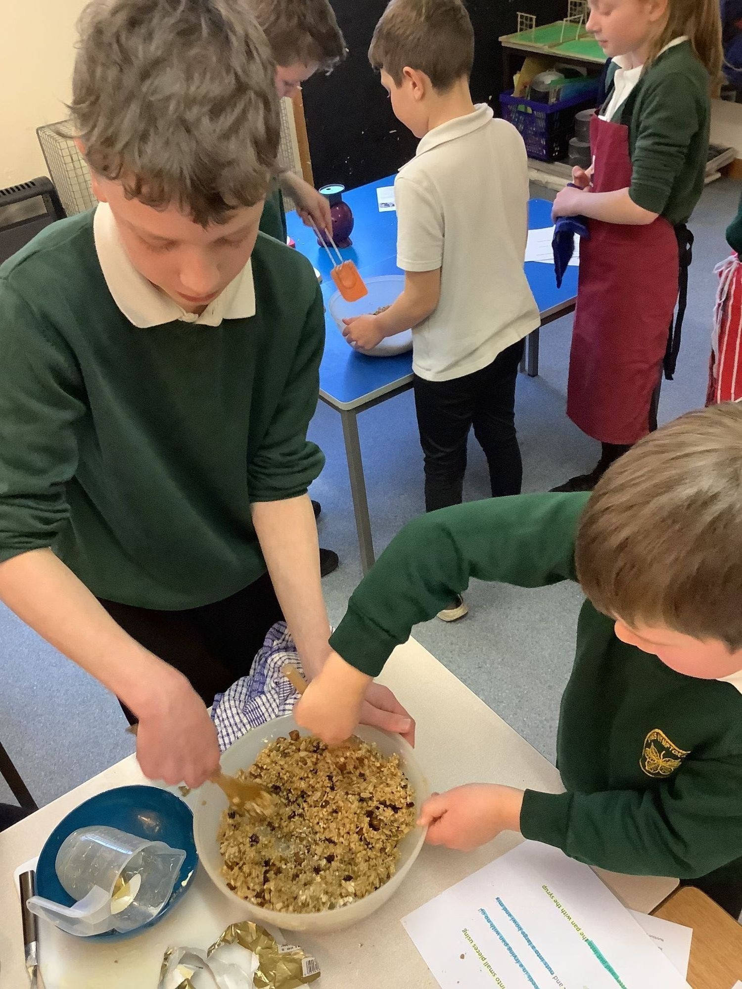 Two children making pasta