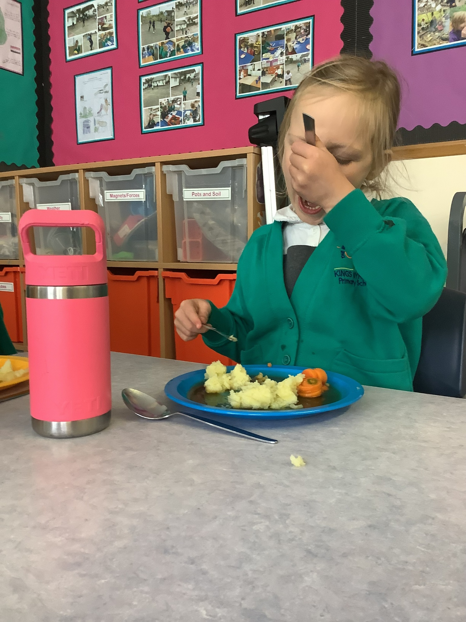 Two children eating a school meal